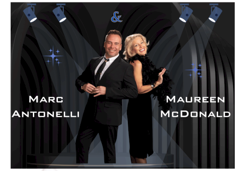 Two people in formal attire pose on a stage under spotlights, with names “Marc Antonelli” and “Maureen McDonald” displayed; a decorative backdrop.