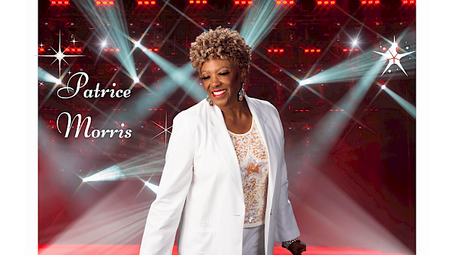 A smiling woman in a white blazer on a stage with bright lights; text reads “Patrice Morris” in cursive on the left.